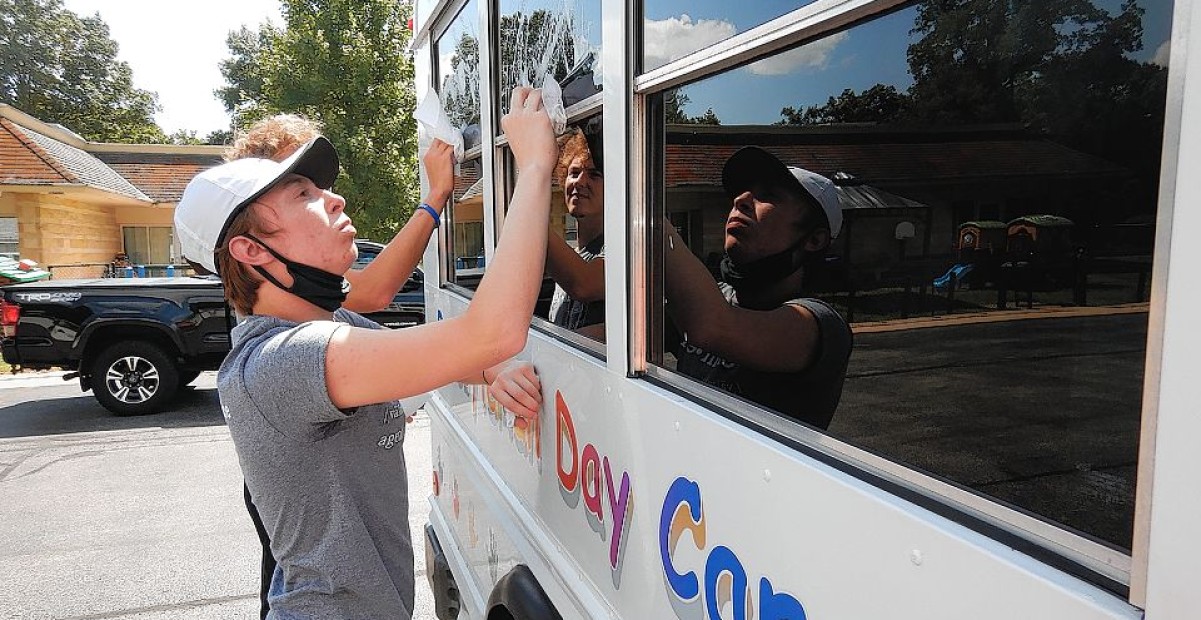 IC first-year student cleans daycare bus.