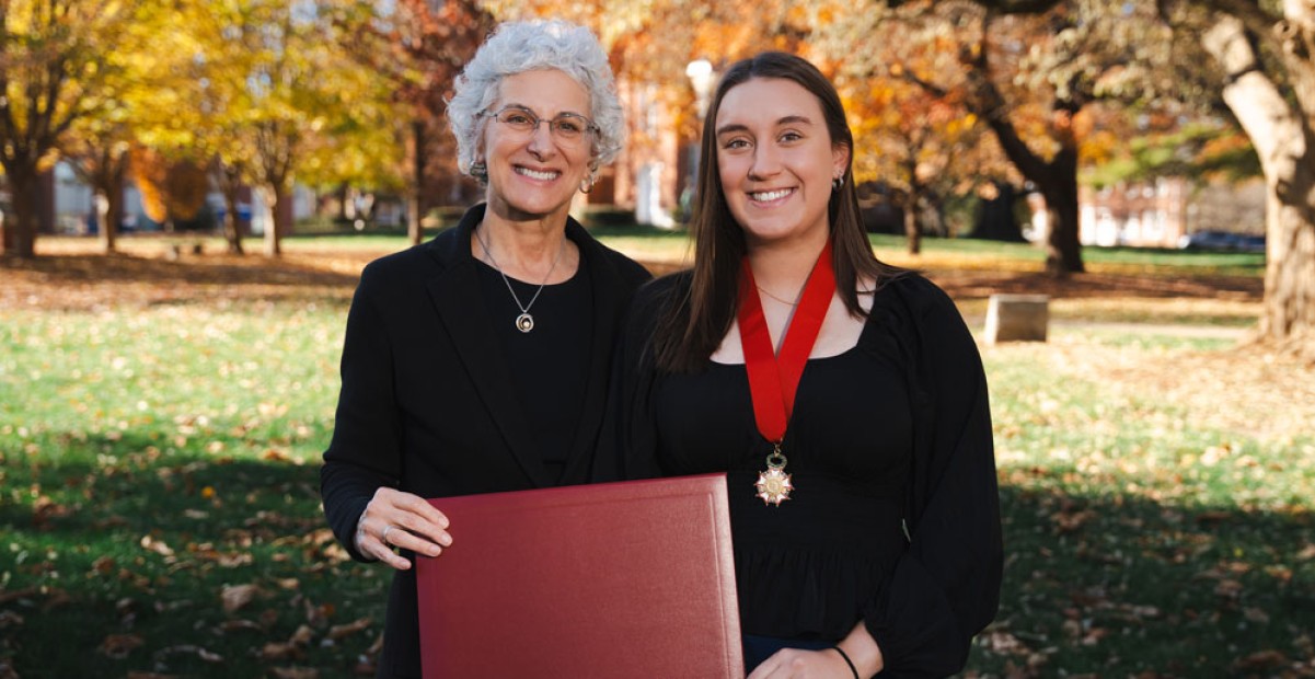 President Barbara A. Farley (left) and Shannon Engmann '24 (right) with Shannon's award on the Quad