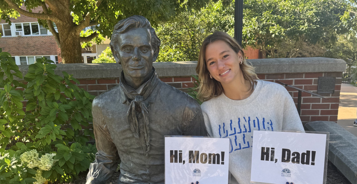 Elena Manuel ’28 posing with a statue of Abraham Lincoln on campus