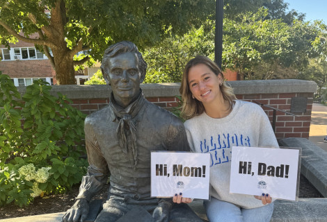Elena Manuel ’28 posing with a statue of Abraham Lincoln on campus