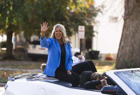 Kristin Van Aken Jamison ’99 smiling and waving as she rides in a parade