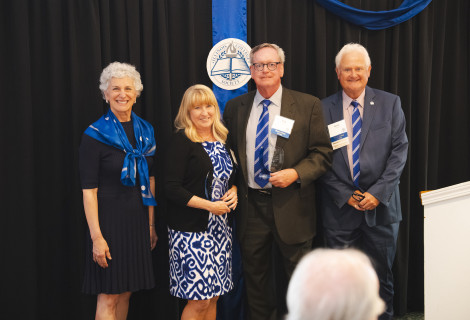 Tom and Ann Bishop Prather '80 accepting award at Society Gala