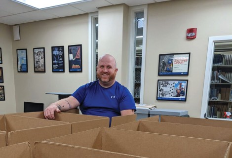 Ryan Roberts, director of Schewe Library packs up copies of The Rambler