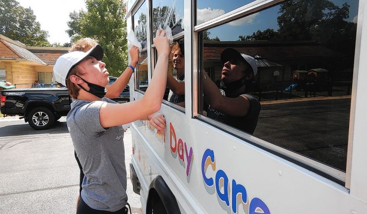IC first-year student cleans daycare bus.