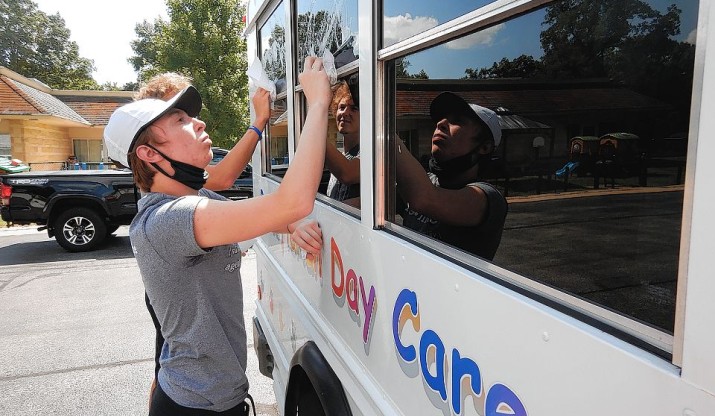 IC first-year student cleans daycare bus.